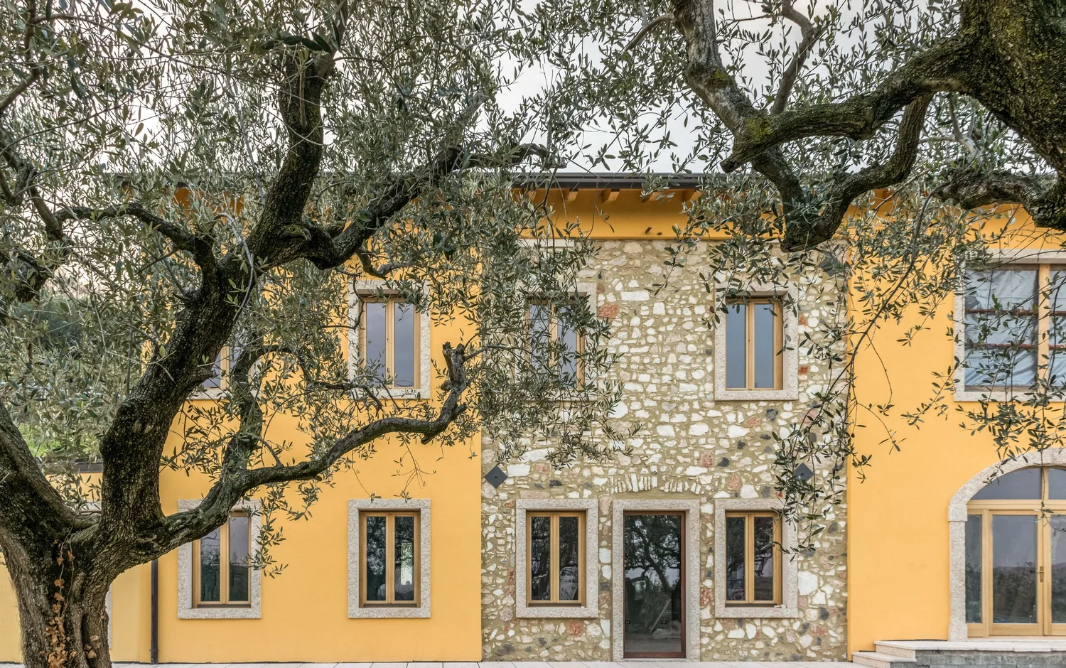 Villa Madamadoré facade framed by olive trees